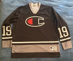 Champion #19 Champion Logo Hockey Jersey Sz L (44) (25in W X 30in L) Black