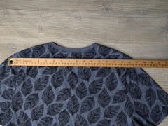 This blue Goodfellow & Co v-neck shirt features a dark leaf pattern.