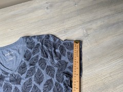 This blue Goodfellow & Co v-neck shirt features a dark leaf pattern.