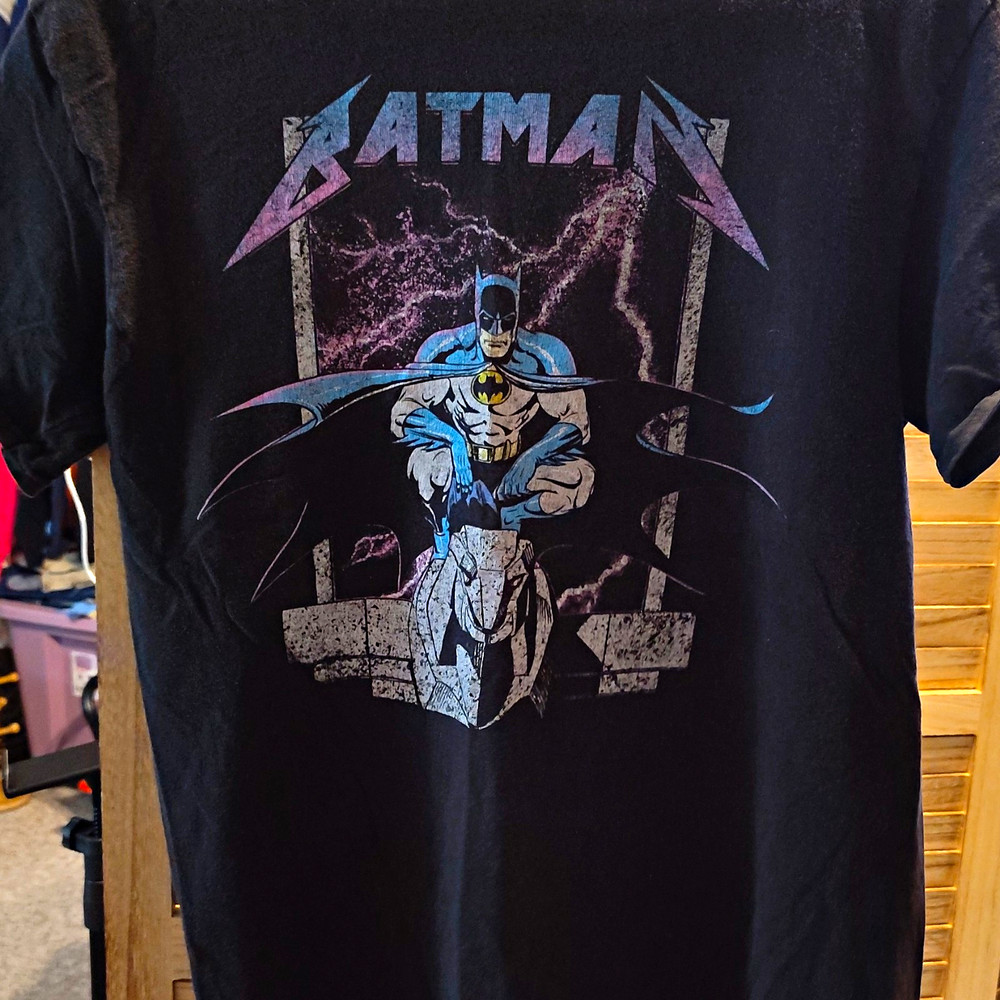 This black Batman t-shirt features a graphic inspired by the Metallica band logo