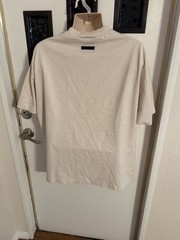 Fear of God Essentials oversized beige/tan graphic T-shirt front arch Logo Clean