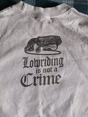 T-Shirt “Lowriding is not a Crime” design printed on a Shaka Wear blank Size L