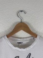 White graphic T-shirt featuring an abstract, hand-drawn fashion