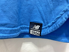 NB New Balance Stretch Blue Pocket T Shirt Unisex size Small Round Slit Hemline