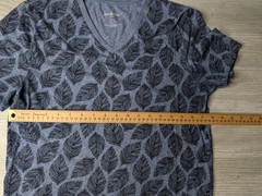 This blue Goodfellow & Co v-neck shirt features a dark leaf pattern.