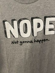 DOM brand graphic tee with the slogan “NOPE – Not gonna happen.”