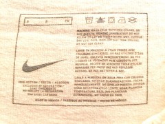 NIKE WHITE TEE SHIRT WITH FULL LENGTH RED SWOOSH LOGO SHORT SLEEVE ADULT SIZE S