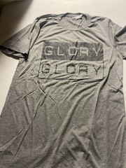 Light gray short sleeve t-shirt with Black “Glory, Glory” logo