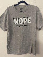 DOM brand graphic tee with the slogan “NOPE – Not gonna happen.”