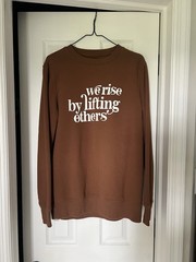 Hand screen printed crew neck “we rise by lifting others” brown medium