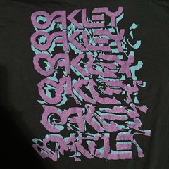 Oakley Black Short Sleeve T-shirt With Purple & Teal Graphic. Size Men’s L