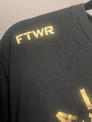 Black Alexa Grasso t-shirt with gold screen-printed graphics. Large