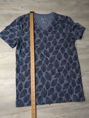 This blue Goodfellow & Co v-neck shirt features a dark leaf pattern.
