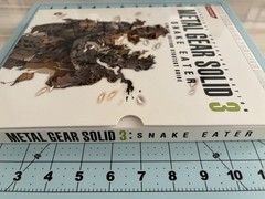Metal Gear Solid collector lot with Uniqlo 25th Anniversary shirt