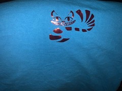 Alice in Wonderland- We’re All Mad Here -Cheshire Cat foil print giant L teal