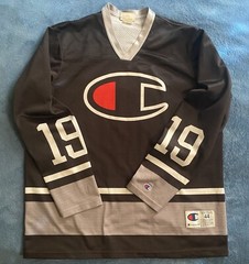 Champion #19 Champion Logo Hockey Jersey Sz L (44) (25in W X 30in L) Black