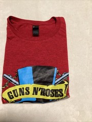 Guns And Roses Red Shirt With Skull Design Wearing A Blue And Black Hat.