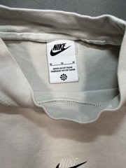 Nike long sleeve mock neck top in Light Bone featuring a small swoosh logo