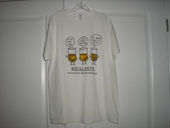 Funny T-Shirt- Realists “The Only Ones Who Really Know What’s Going On” Size L