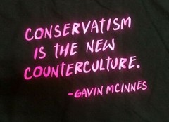 Banned Galvin Mcinnes T-Shirt Size XL Black with Pink Writing. Quote on back.