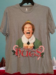 NWOT – NEED HUGS ELF Movie Image Gray Adult Size L Short Sleeve Tee