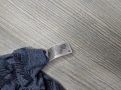 This blue Goodfellow & Co v-neck shirt features a dark leaf pattern.
